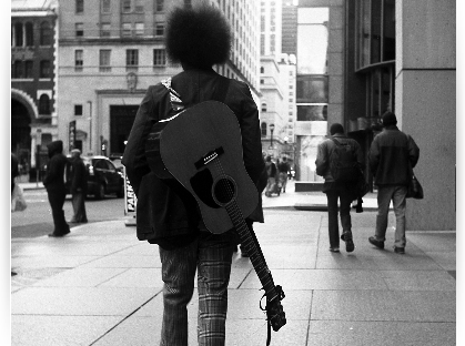 guitar strapped on back